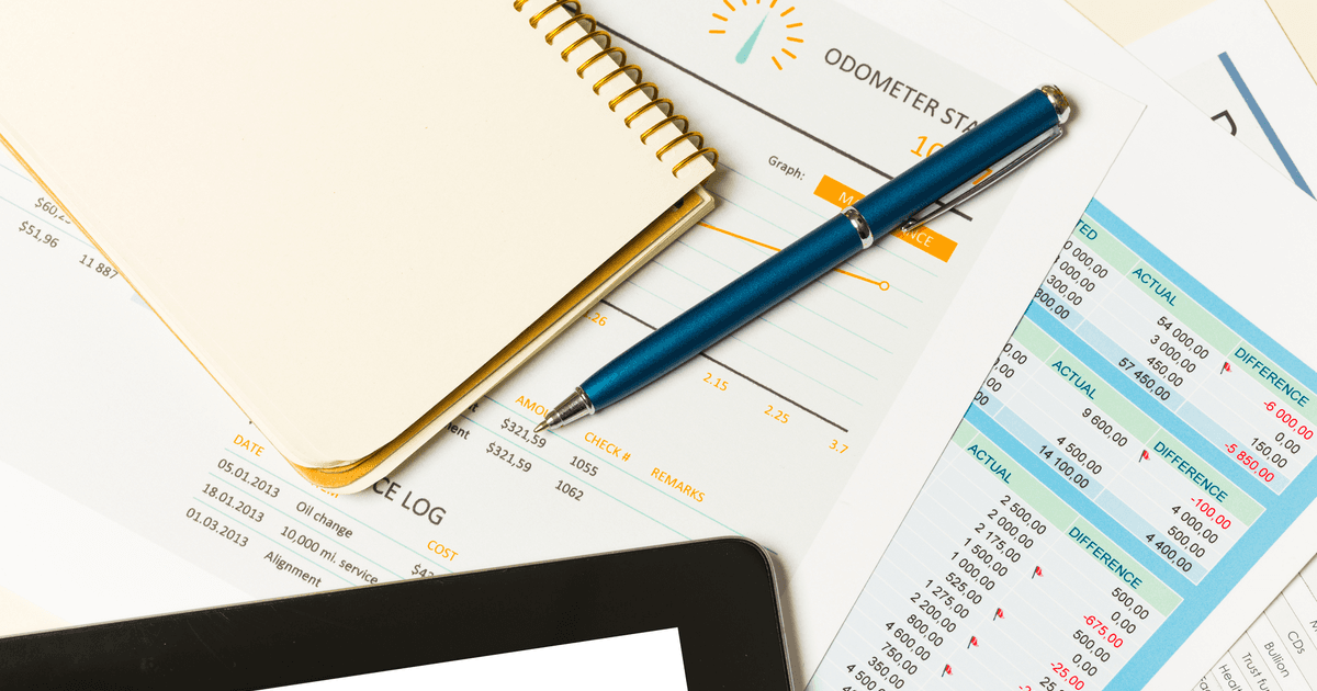 An overview of business reports and notes on a desk in a modern office environment