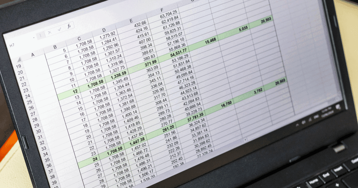 Dense spreadsheet of numbers and formulas on a laptop screen