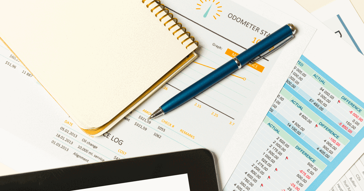 An overview of business reports and notes on a desk in a modern office environment