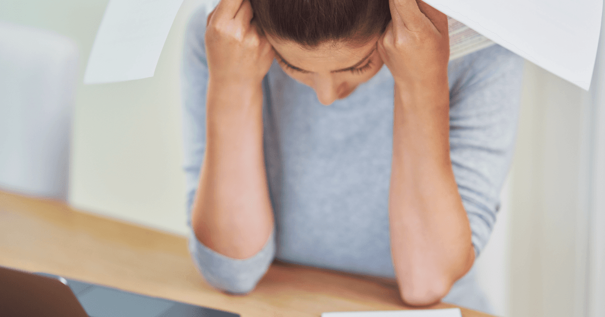 Young woman struggling with paperwork and bills