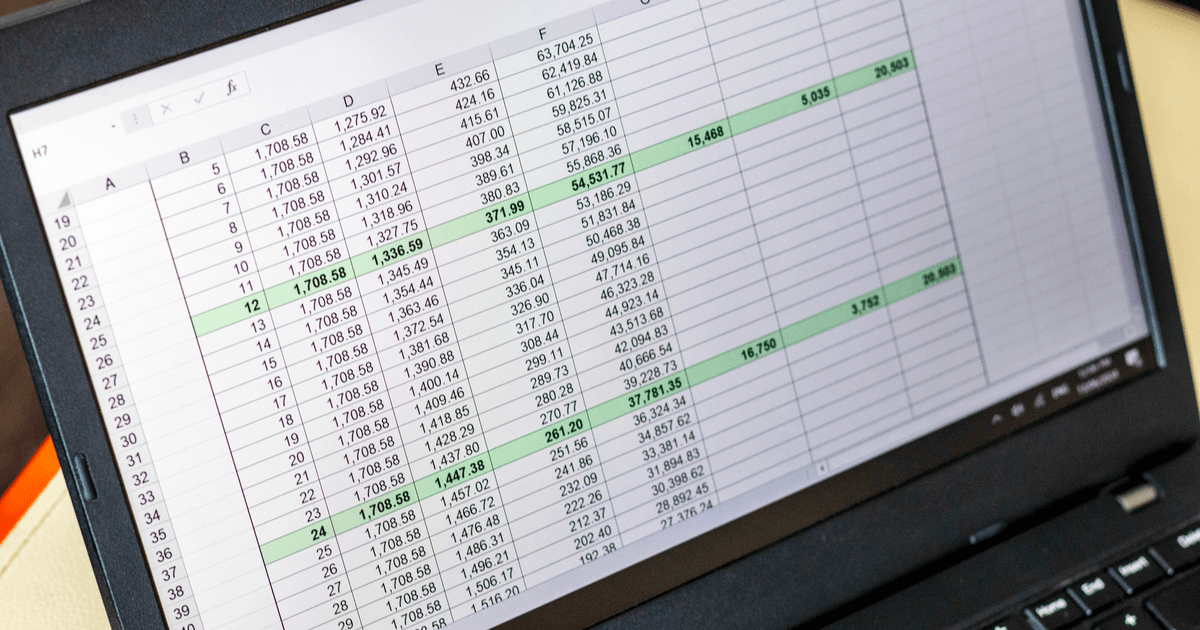 Dense spreadsheet of numbers and formulas on a laptop screen